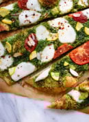Homemade arugula-almond pesto pizza with a simple whole wheat crust
